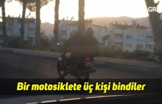 Bir motosiklete üç kişi bindiler